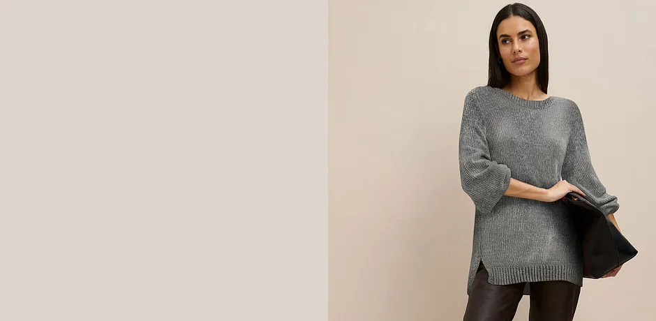 Grå, lang genser kombinert med mørk bukse.