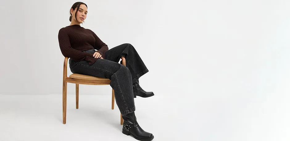 Langermet topp, sorte jeans og skinnstøvletter.