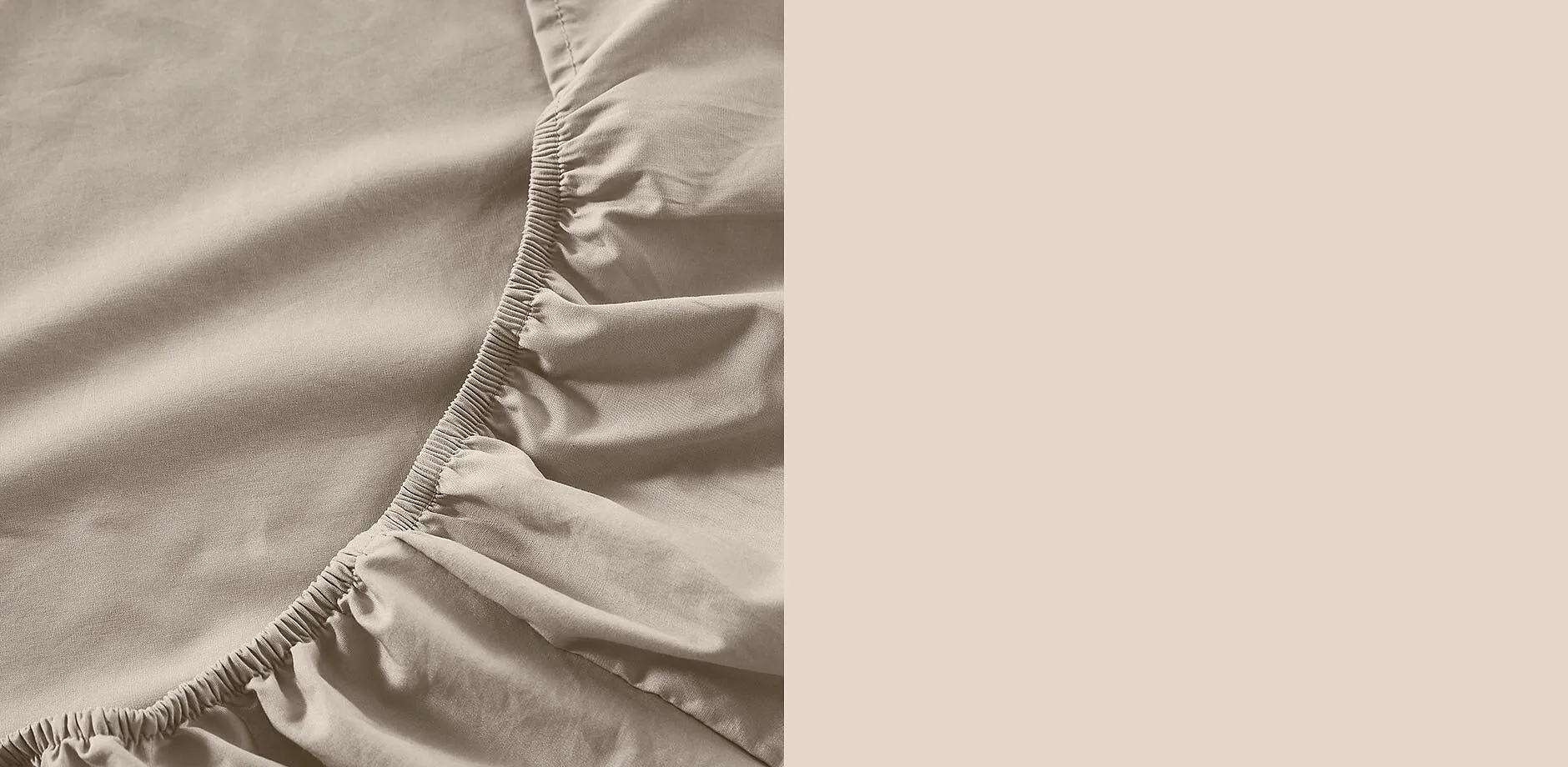 Beige stretchlaken med strikk.