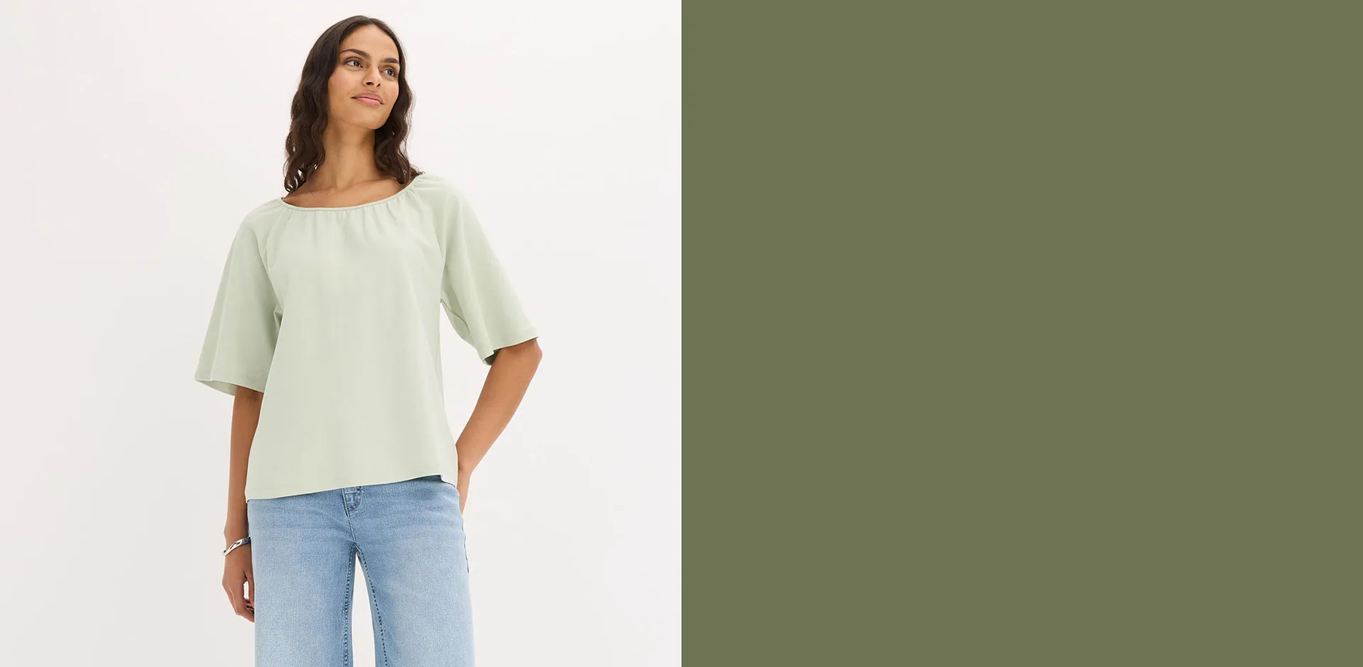 Flott, lysegr&oslash;nn bluse med vide ermer kombinert med avslappede jeans.