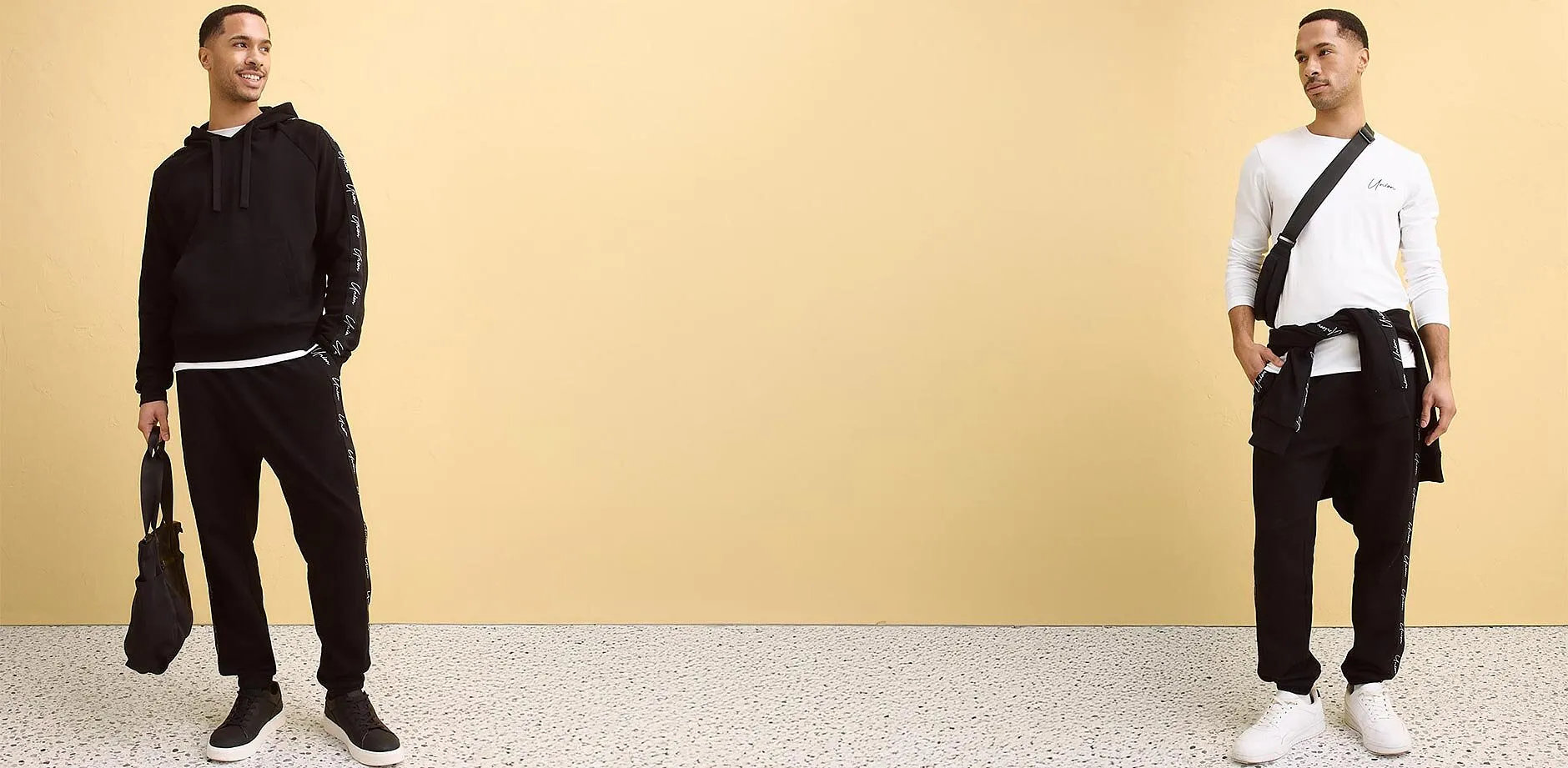 Hvit, langermet shirt, sort joggebukse og sort skulderveske.