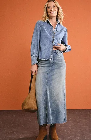 Denim-look fra topp til tå: denimjakke og lang denimskjørt kombinert med brune støvler.