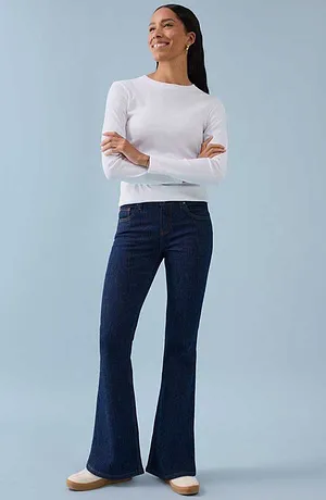 Hvit, langermet skjorte kombinert med mørkeblå slengbukse for en tidløs, elegant look.