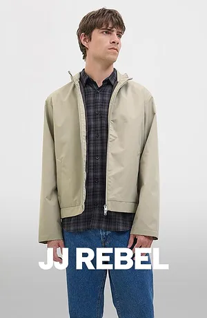 Rutete skjorte under beige jakke kombinert med bluejeans.