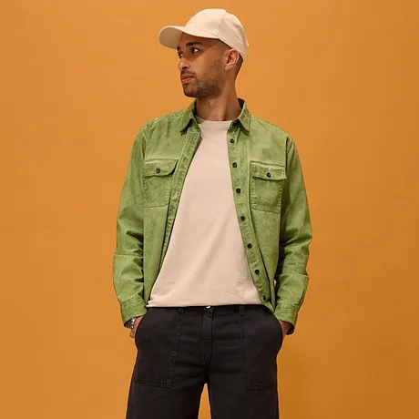 Grønn skjorte over hvit T-skjorte, mørke shorts, hvite sneakers og baseballcaps.