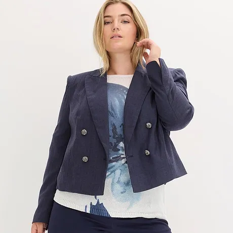 Marineblå blazer over blå, mønstret topp.