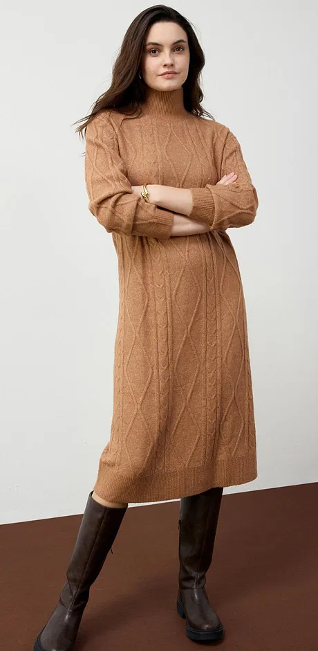 En varm, kamelbrun strikket kjole kombinert med brune skinnstøvletter utstråler høstlig eleganse.