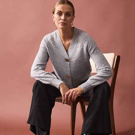 Elegant, grå cardigan med store knapper kombinert med sort bukse.