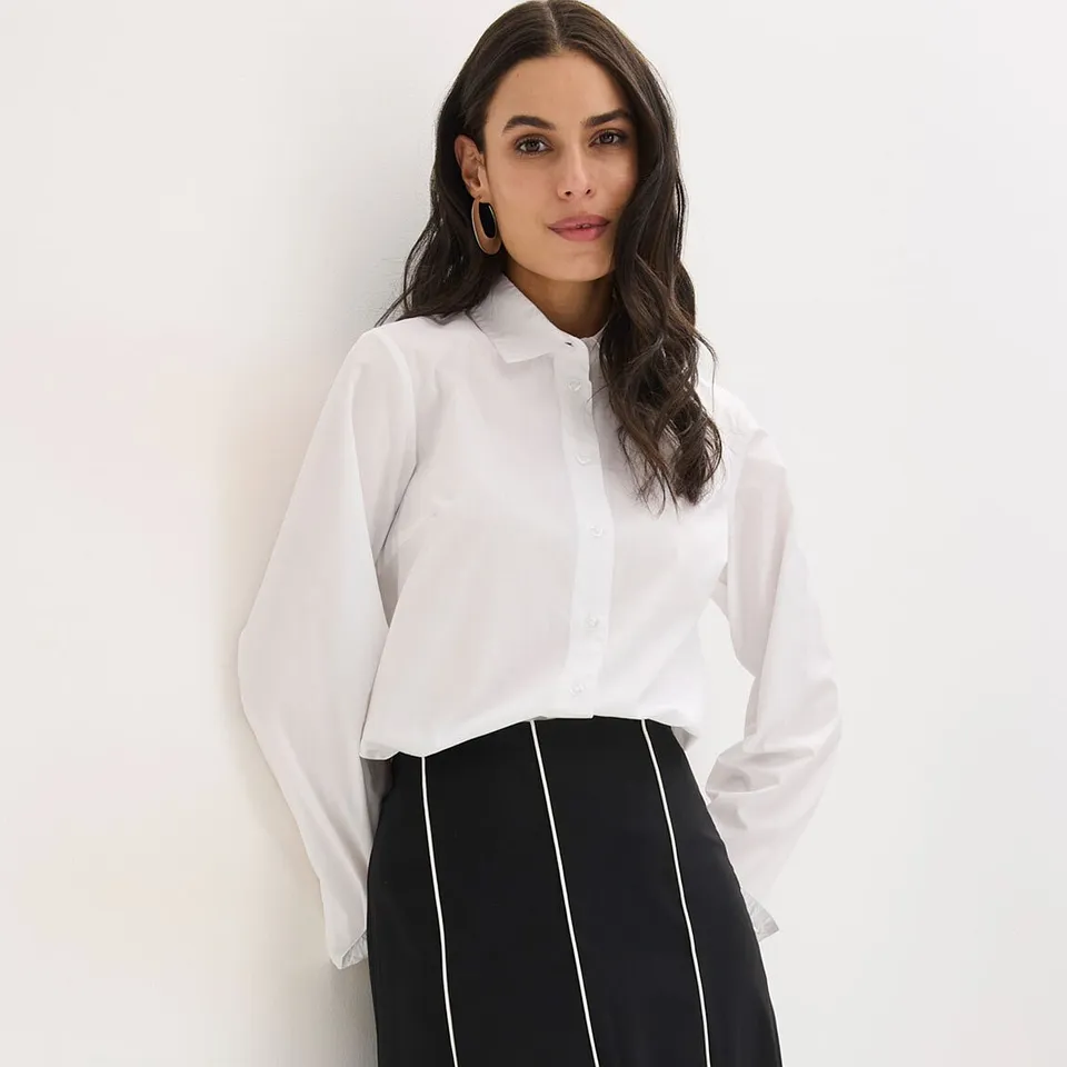 Hvit skjorte med krage og skjørt i sort og hvitt med vertikale striper.